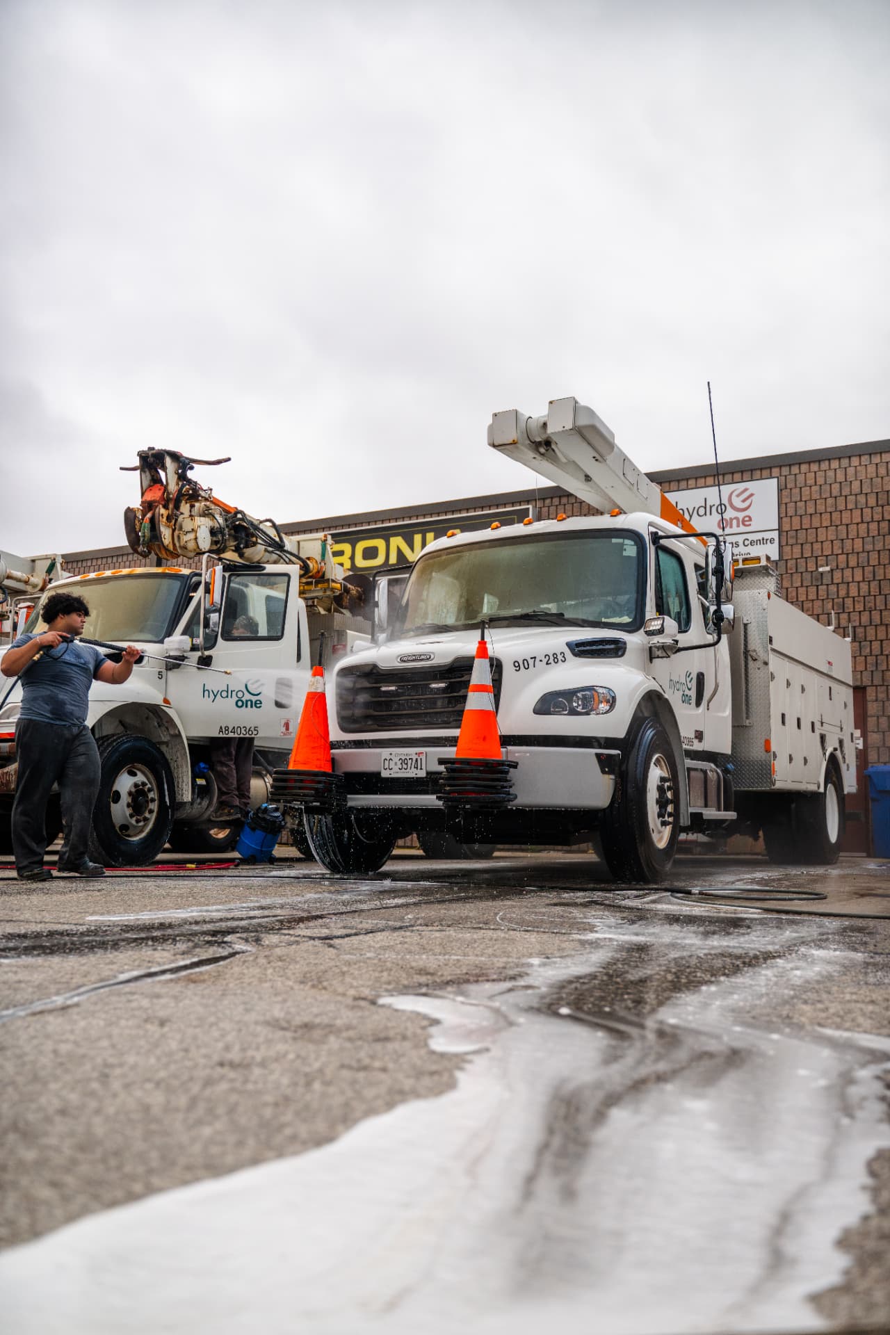 Refined Mobile Wash crew member pressure washing a utility fleet truck on-site