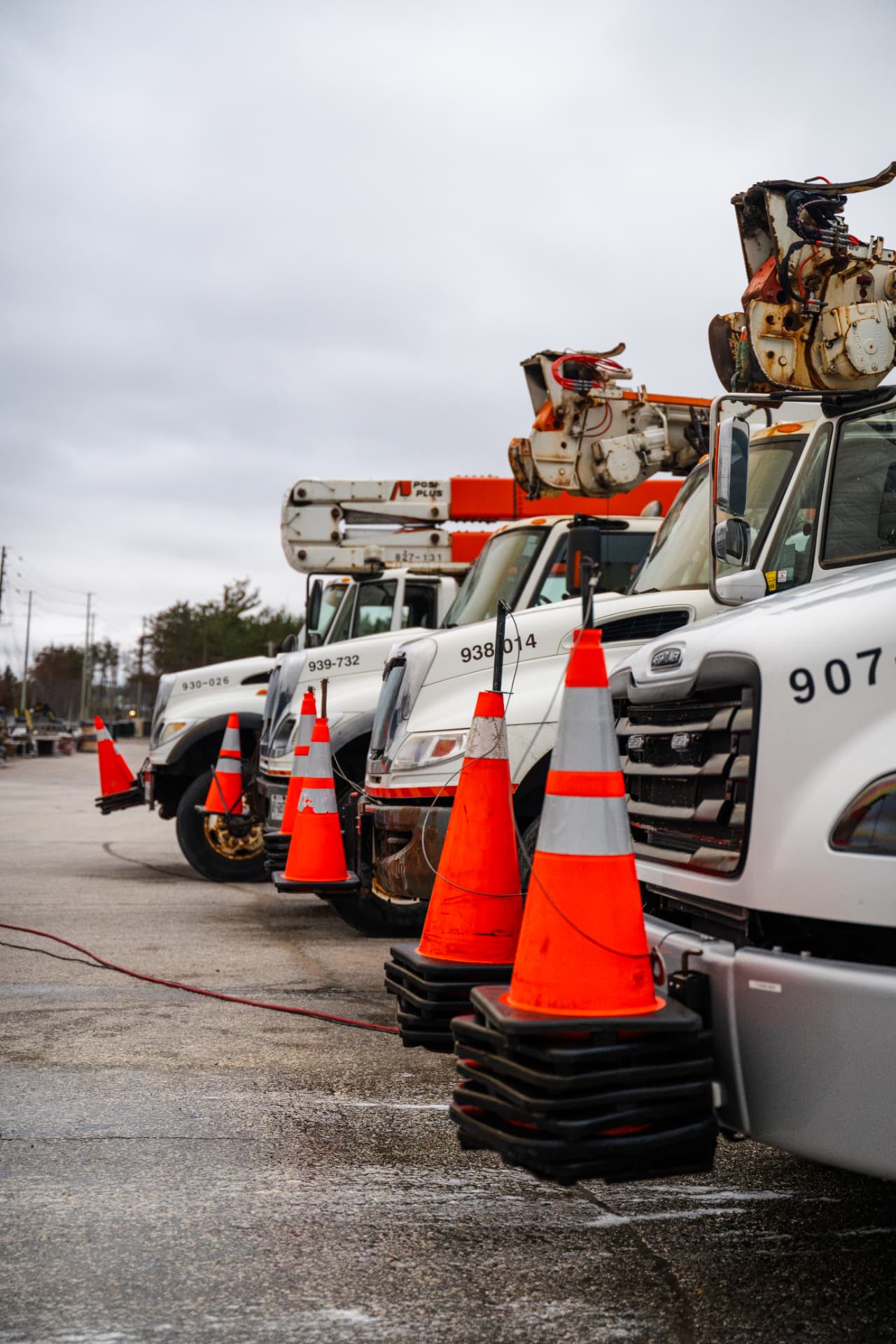 Row of commercial utility trucks lined up for on-site fleet washing in Simcoe County